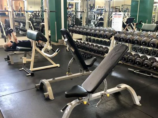 Benches and dumbbells in the free-weight area at HFH gym in Waupaca, WI