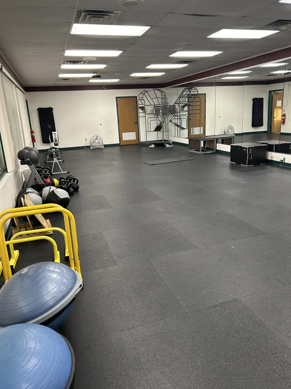 Sunlit functional-training studio with stability balls and open floor at HFH gym in Waupaca, WI