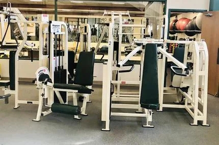 Row of plate-loaded and selectorized strength machines at HFH gym in Waupaca, WI